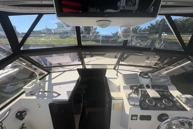 Slide: The Image of Interior view of a 1995 Carolina Classic 28 boat cockpit with navigation equipment. - 15