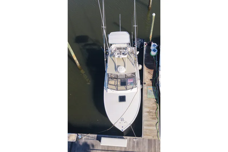 Slide: The Image of Overhead view of a 1995 Carolina Classic 28 boat docked at a marina. - 11