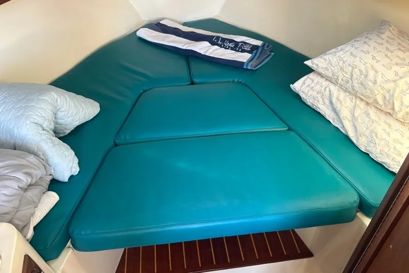 Slide: The Image of Cozy cabin interior of 1995 Carolina Classic 28 with teal cushions and pillows. - 34
