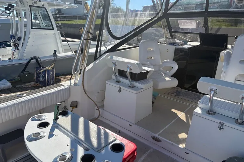 Slide: The Image of Interior of a 1995 Carolina Classic 28 boat with seating and fishing equipment. - 17