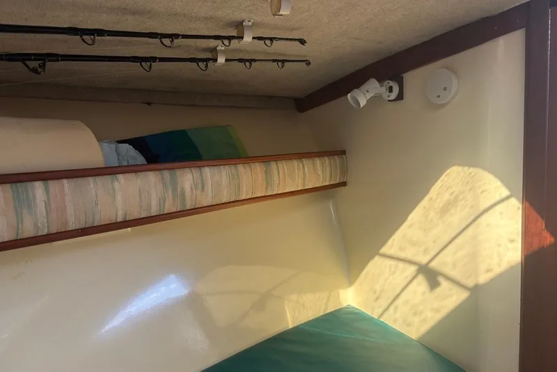 Slide: The Image of Interior cabin of a 1995 Carolina Classic 28 boat with fishing rods and sunlight. - 36