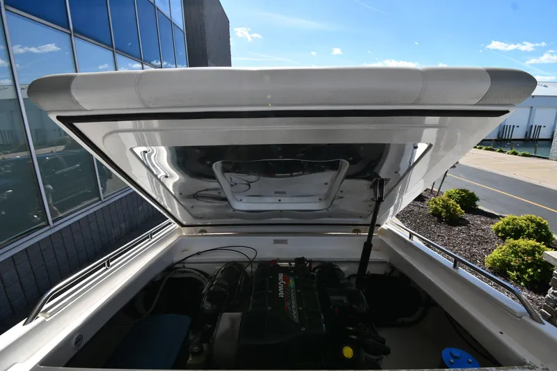 Slide: The Image of 1995 Fountain 24 Competition boat engine compartment with open hatch, outdoor setting. - 25