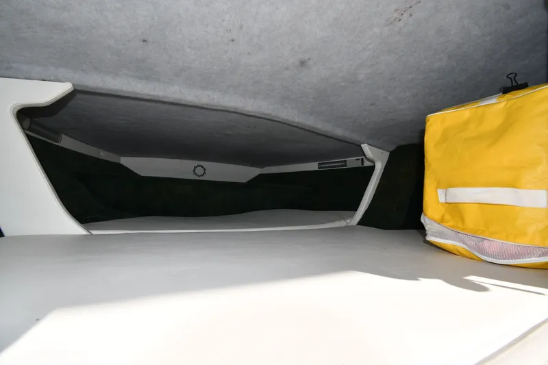 Slide: The Image of Interior cabin of a 1995 Fountain 24 Competition boat with a yellow storage bag. - 24