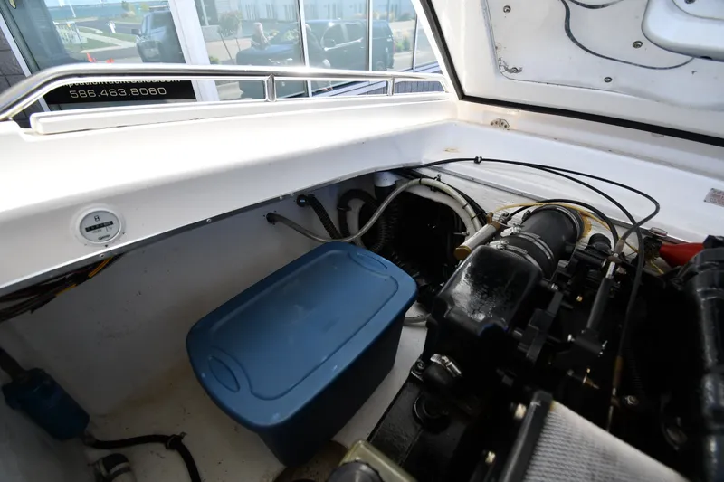 Slide: The Image of Engine compartment of a 1995 Fountain 24 Competition boat, featuring storage and mechanical components. - 28