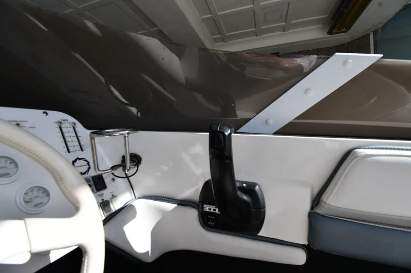 Slide: The Image of Interior view of a 1995 Fountain 24 Competition boat dashboard with steering wheel and controls. - 14