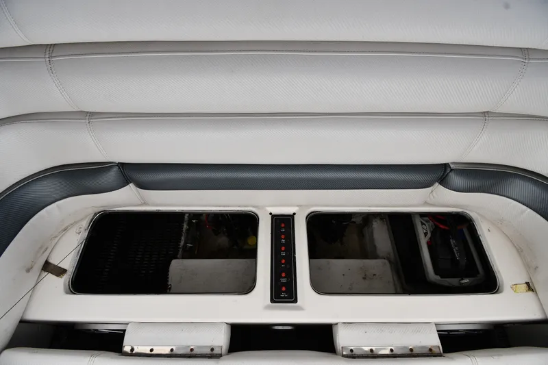 Slide: The Image of Interior of a 1995 Fountain 24 Competition boat, featuring white and gray seating. - 31