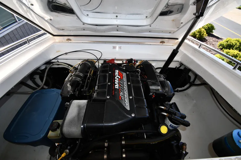 Slide: The Image of Engine compartment of a 1995 Fountain 24 Competition boat, featuring a powerful MerCruiser 502 Magnum engine. - 26