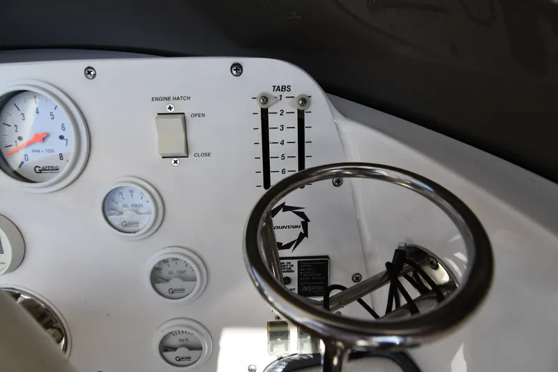 Slide: The Image of Dashboard of a 1995 Fountain 24 Competition boat with gauges and controls. - 15