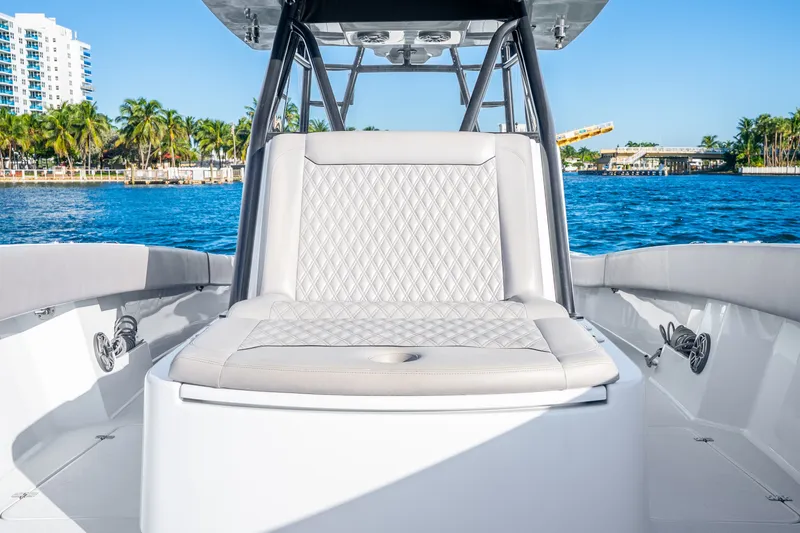 Slide: The Image of 2024 Conch 41 boat interior with luxurious seating, set against a scenic waterfront backdrop. - 40