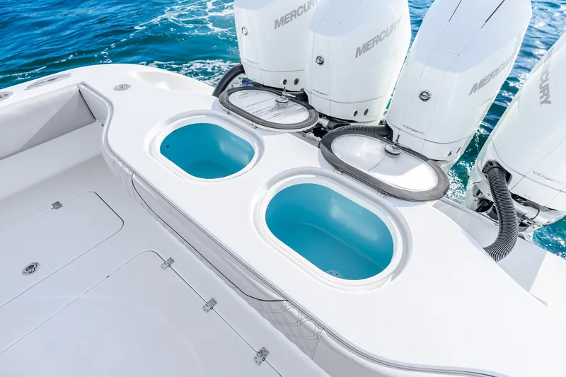 Slide: The Image of 2024 Conch 41 boat with dual livewells and Mercury Verado engines on blue ocean. - 17