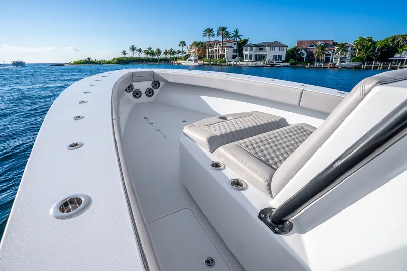 Slide: The Image of 2024 Conch 41 boat interior with luxurious seating, cruising on a scenic waterfront. - 41