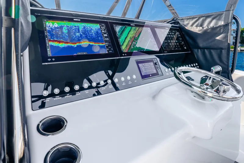 Slide: The Image of 2024 Conch 41 boat dashboard with advanced navigation displays and controls. - 24