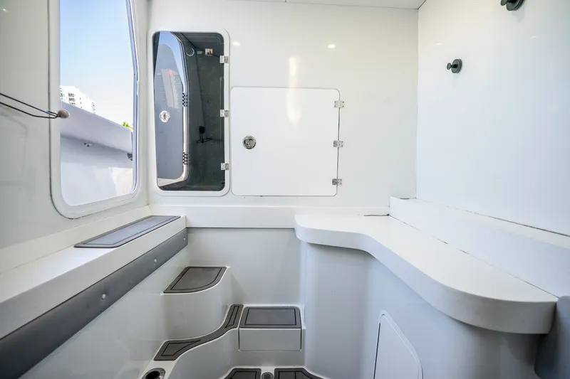 Slide: The Image of 2024 Conch 41 boat interior with sleek white design and modern features. - 49