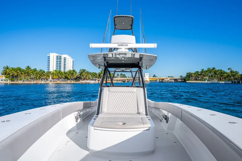 Slide: The Image of 2024 Conch 41 boat on water, with clear blue sky and palm trees in background. - 45