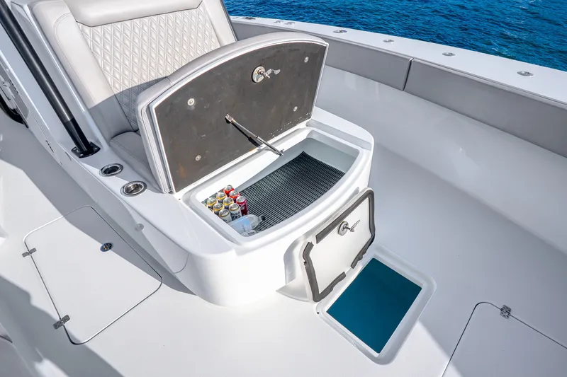 Slide: The Image of 2024 Conch 41 boat interior with open storage compartment and beverage cans. - 43