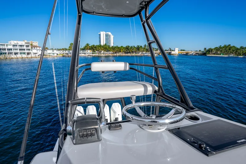 Slide: The Image of 2024 Conch 41 boat helm with ocean view, featuring modern steering and controls. - 36