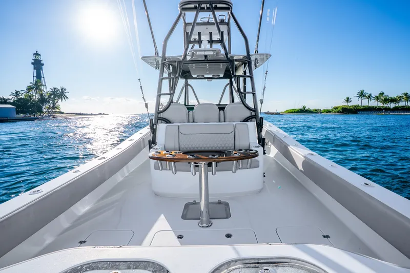 Slide: The Image of 2024 Conch 41 boat on water near lighthouse and palm trees. - 14