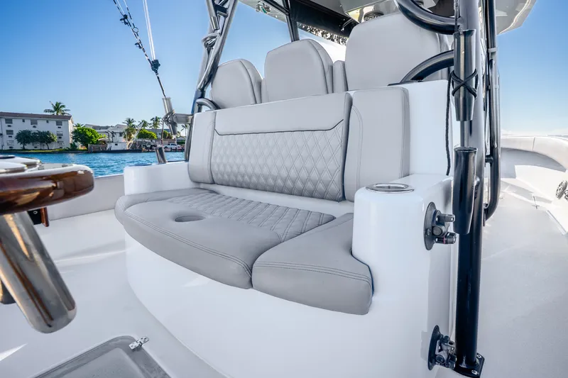 Slide: The Image of Luxurious seating on 2024 Conch 41 boat, featuring elegant gray upholstery and scenic waterfront view. - 21