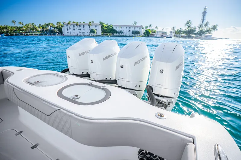 Slide: The Image of 2024 Conch 41 boat with four Mercury outboard engines on clear blue water. - 16