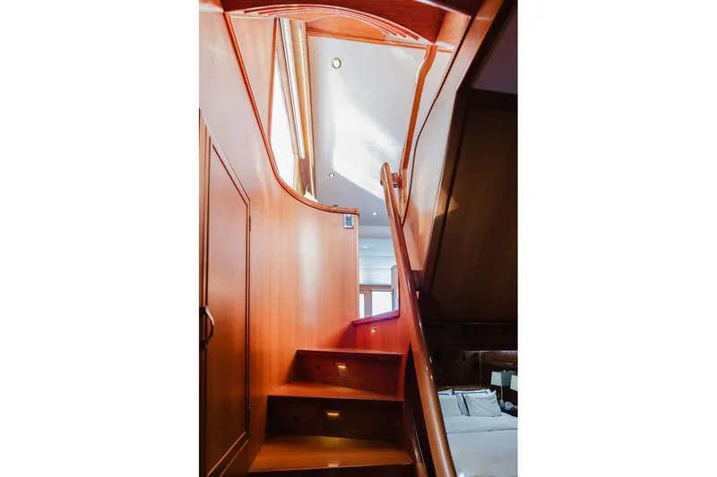 Slide: The Image of Interior staircase of 1999 Ocean Alexander 680 Classicco yacht, featuring elegant wooden design. - 55