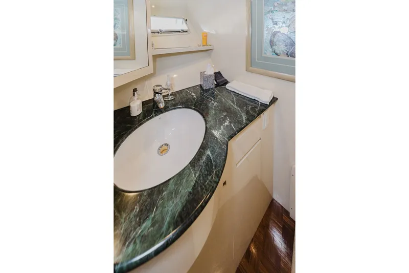 Slide: The Image of Luxurious bathroom sink with marble countertop on 1999 Ocean Alexander 680 Classicco yacht. - 66