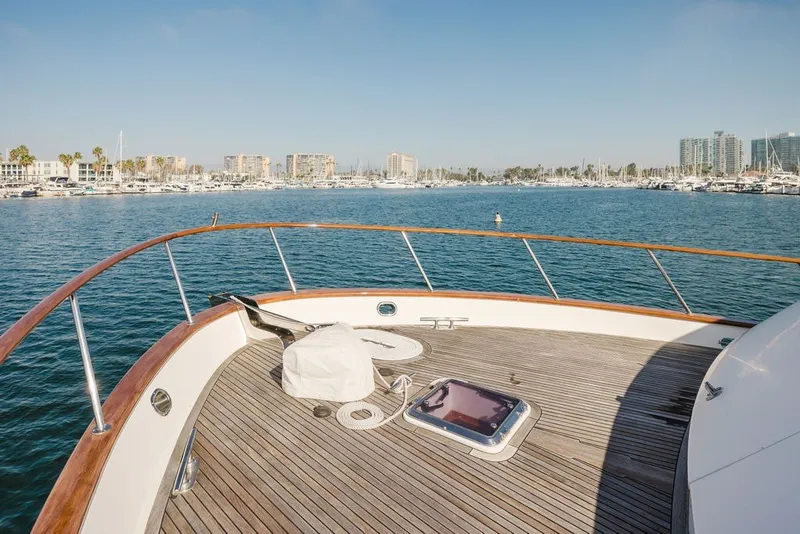 Slide: The Image of Foredeck of 1999 Ocean Alexander 680 Classicco yacht overlooking marina and cityscape. - 16
