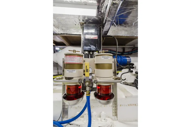 Slide: The Image of Engine room of 1999 Ocean Alexander 680 Classicco yacht, featuring dual fuel filters. - 109