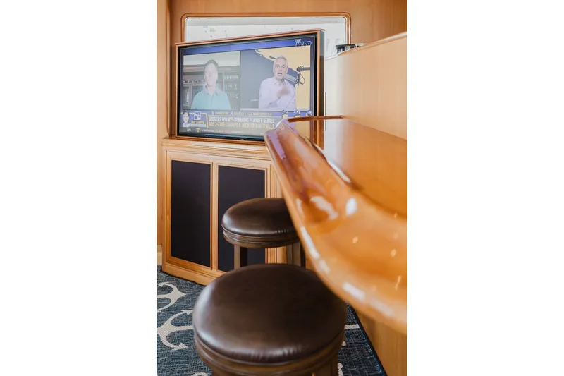Slide: The Image of Interior of 1999 Ocean Alexander 680 Classicco yacht with bar stools and TV. - 31