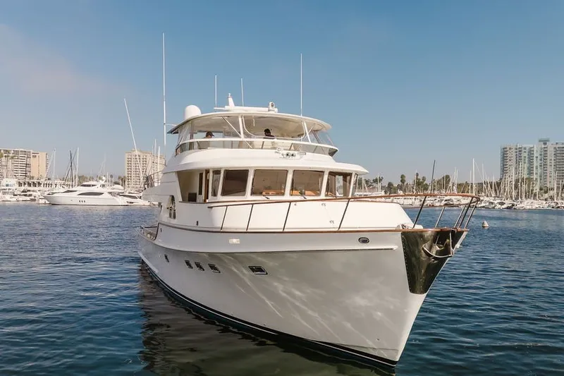 Slide: The Image of 1999 Ocean Alexander 680 Classicco yacht docked in a marina, clear blue sky. - 111