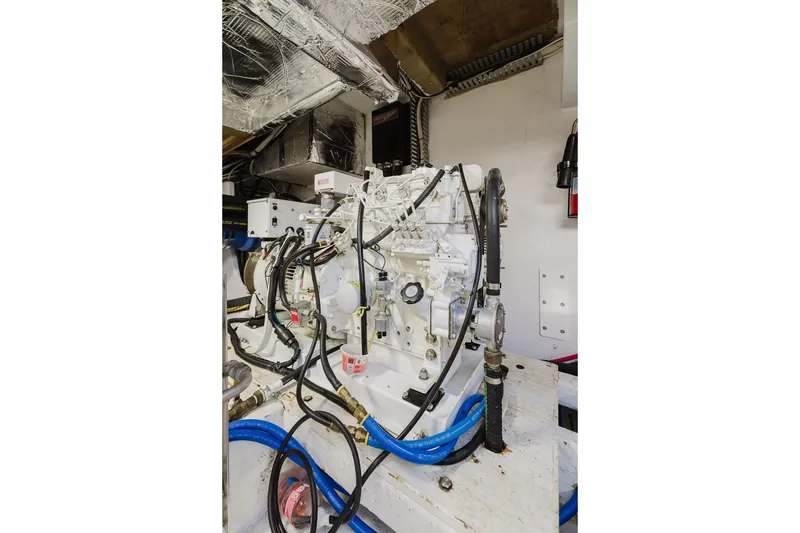 Slide: The Image of Engine room of 1999 Ocean Alexander 680 Classicco yacht, showcasing mechanical components and wiring. - 104