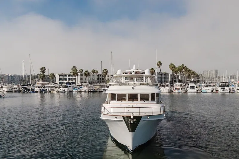 Slide: The Image of Front view of a 1999 Ocean Alexander 680 Classicco yacht in a marina setting. - 126