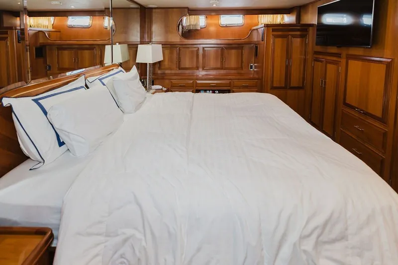 Slide: The Image of Luxurious bedroom interior of 1999 Ocean Alexander 680 Classicco yacht with elegant wood paneling. - 60