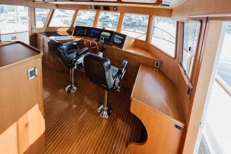 Slide: The Image of Luxurious 1999 Ocean Alexander 680 Classicco yacht interior with polished wood and modern navigation equipment. - 48