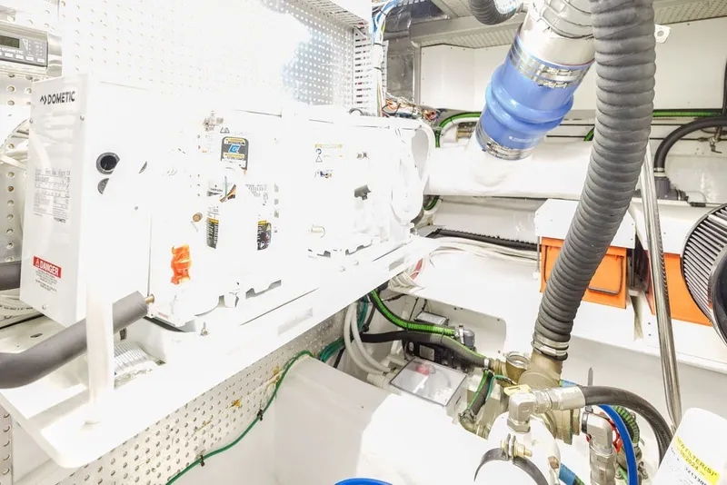 Slide: The Image of Engine room of 1999 Ocean Alexander 680 Classicco yacht, featuring mechanical components and piping. - 98