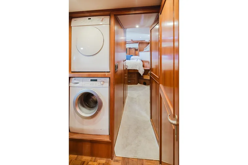Slide: The Image of Laundry area and hallway leading to bedroom on 1999 Ocean Alexander 680 Classicco yacht. - 77