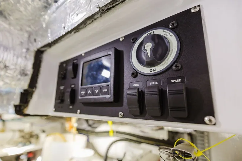 Slide: The Image of Control panel of a 1999 Ocean Alexander 680 Classicco yacht, featuring switches and a display. - 97