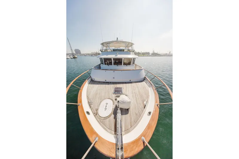 Slide: The Image of 1999 Ocean Alexander 680 Classicco yacht on calm water, showcasing elegant deck design. - 15