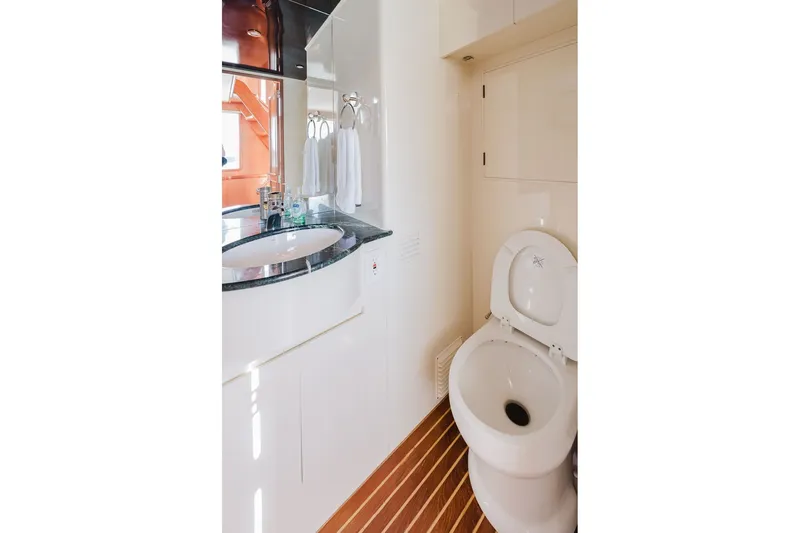 Slide: The Image of Bathroom interior of 1999 Ocean Alexander 680 Classicco yacht, featuring sink and toilet. - 36