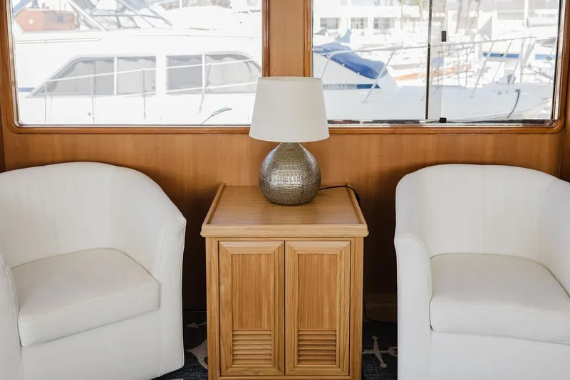 Slide: The Image of Interior of 1999 Ocean Alexander 680 Classicco yacht with white chairs and wooden table. - 27