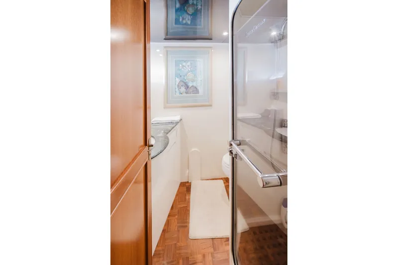 Slide: The Image of Luxurious bathroom interior of 1999 Ocean Alexander 680 Classicco yacht, featuring elegant wood finishes. - 73