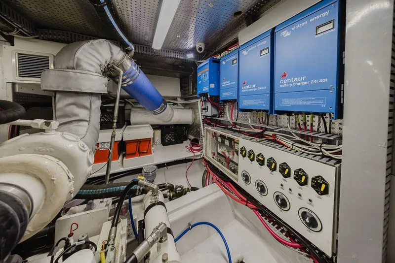 Slide: The Image of Engine room of 1999 Ocean Alexander 680 Classicco with battery chargers and control panel. - 86