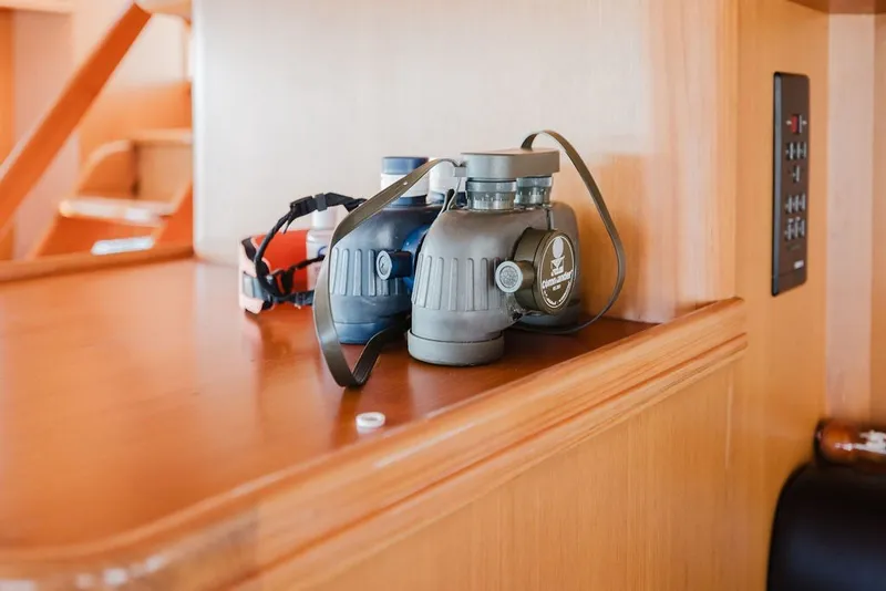 Slide: The Image of Binoculars on wooden shelf inside 1999 Ocean Alexander 680 Classicco yacht interior. - 52