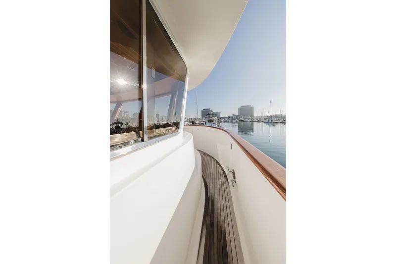 Slide: The Image of Side deck view of 1999 Ocean Alexander 680 Classicco yacht in marina. - 18
