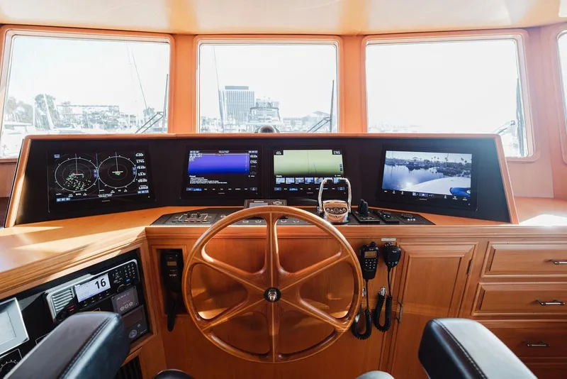 Slide: The Image of 1999 Ocean Alexander 680 Classicco yacht helm with navigation screens and wooden steering wheel. - 40