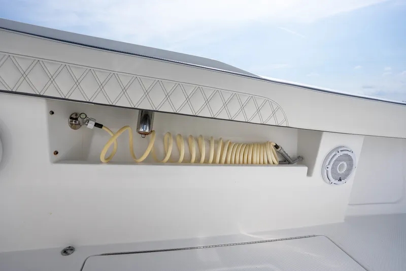 Slide: The Image of 2023 Front Runner 39 Center Console boat with hose storage and speaker detail. - 36