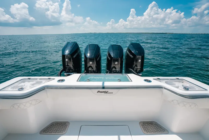 Slide: The Image of 2023 Front Runner 39 Center Console boat with four Mercury engines on open water. - 55