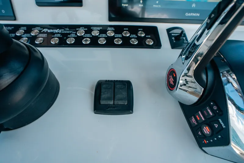 Slide: The Image of Control panel of 2023 Front Runner 39 Center Console boat with throttle and switches. - 65