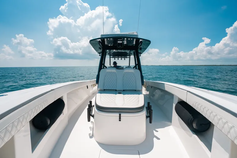 Slide: The Image of 2023 Front Runner 39 Center Console boat cruising on open water under blue sky. - 73