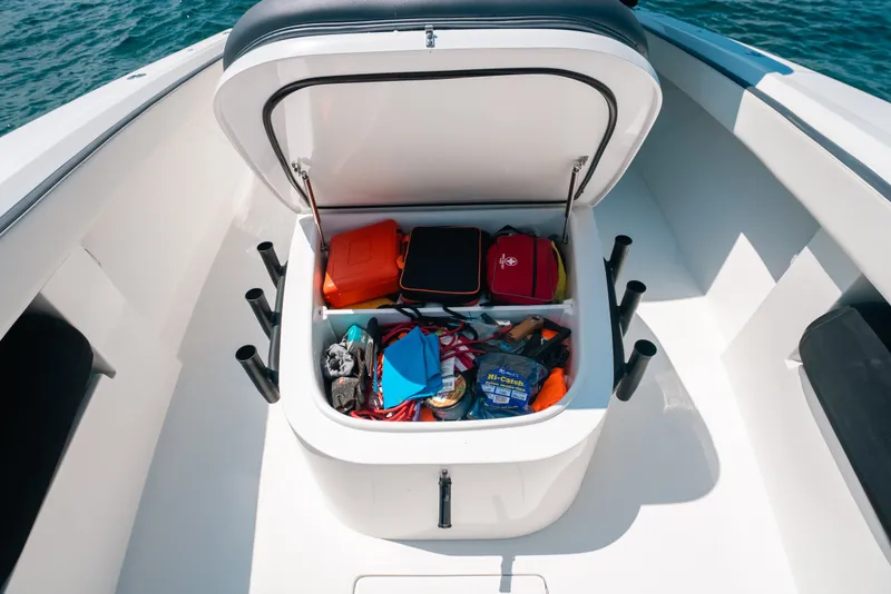 Slide: The Image of Storage compartment on 2023 Front Runner 39 Center Console boat, filled with gear and accessories. - 53