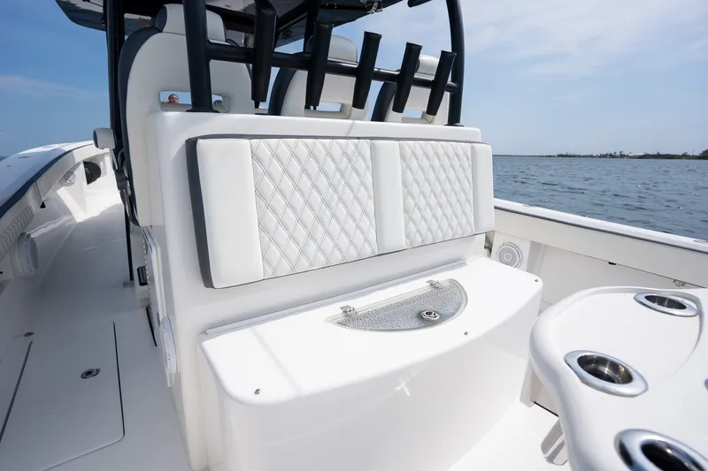 Slide: The Image of 2023 Front Runner 39 Center Console boat interior with cushioned seating and rod holders. - 34